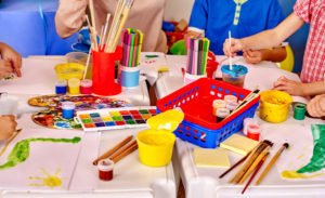 Pre-Kindergarten Group kids hands holding colored paper