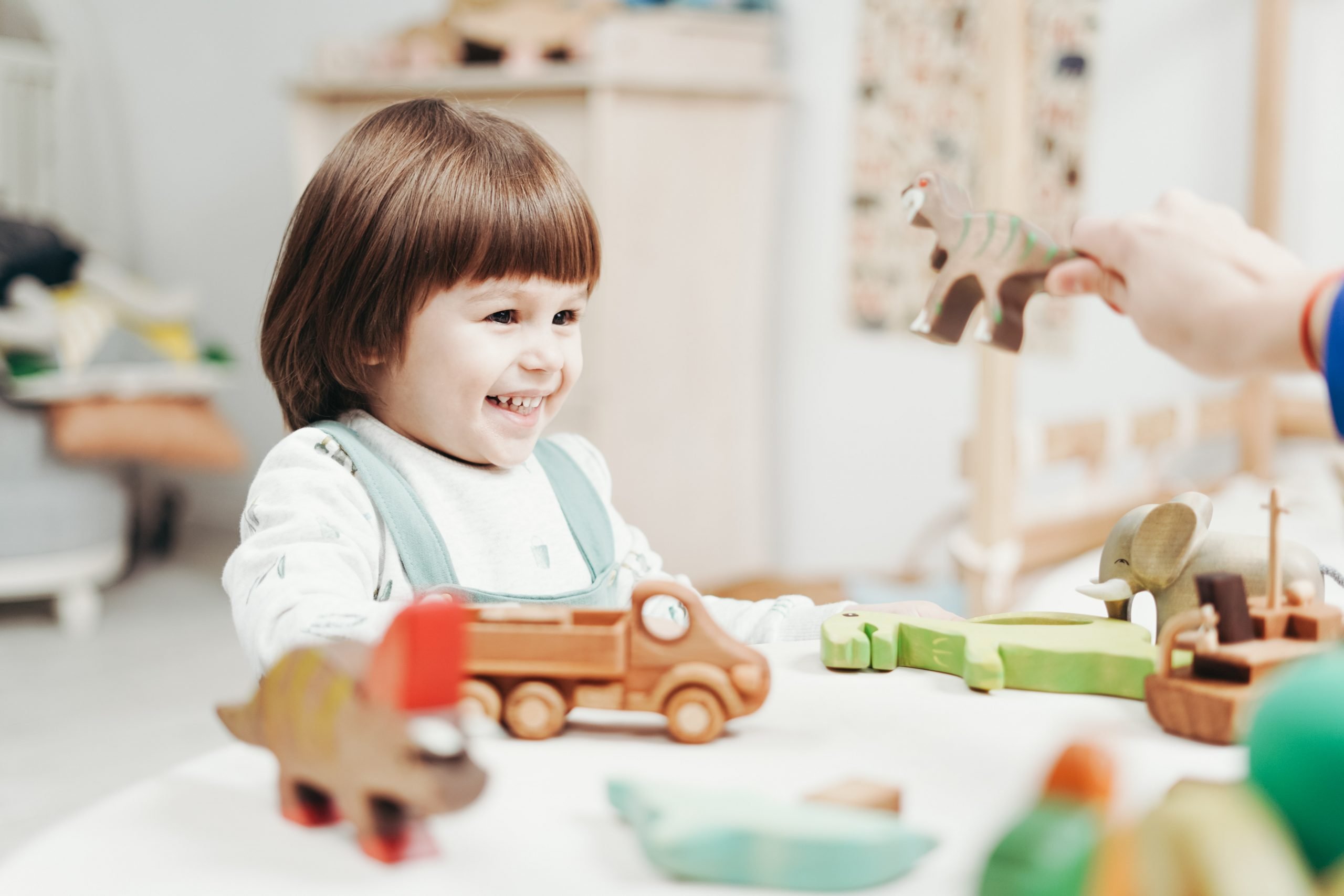 Child playing at daycare with wood toys