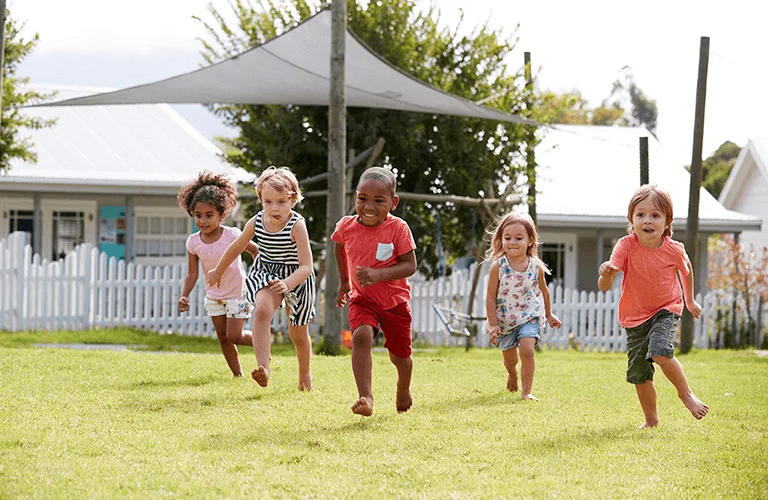 Children in the backyard running at a daycare near me