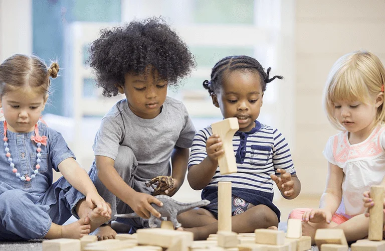 3 children playing with blocks at a Calgary daycare