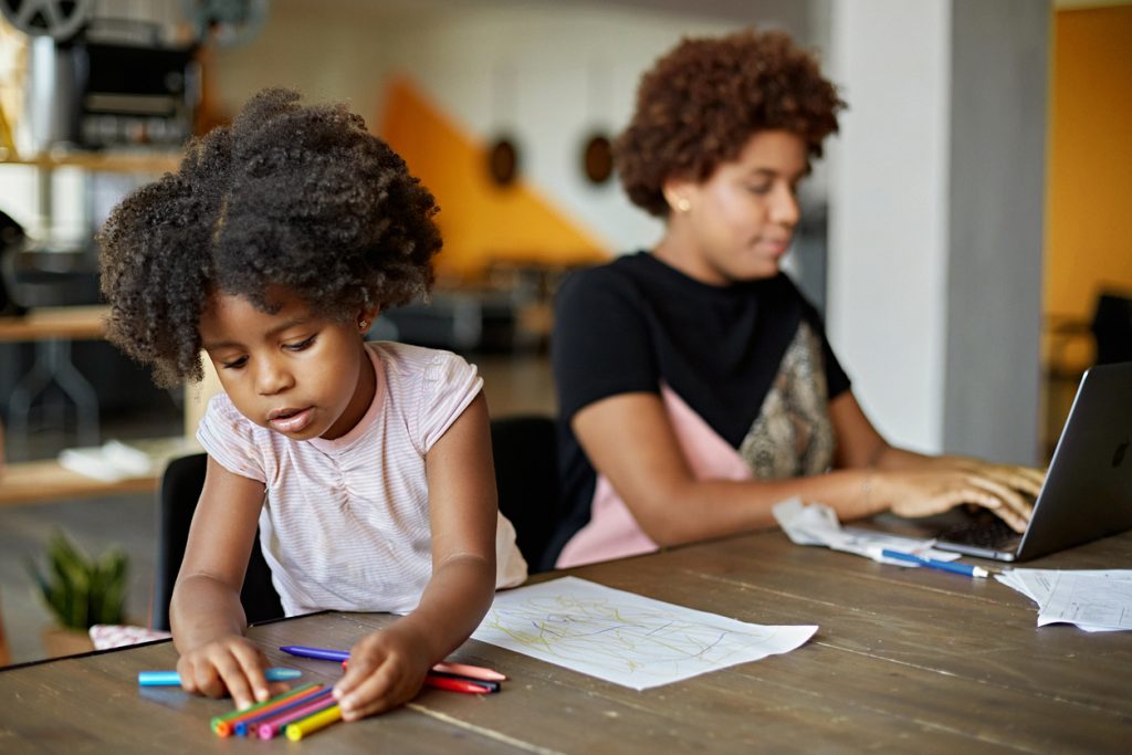 Child Drawing and Mother Working at Home in Time of COVID-19