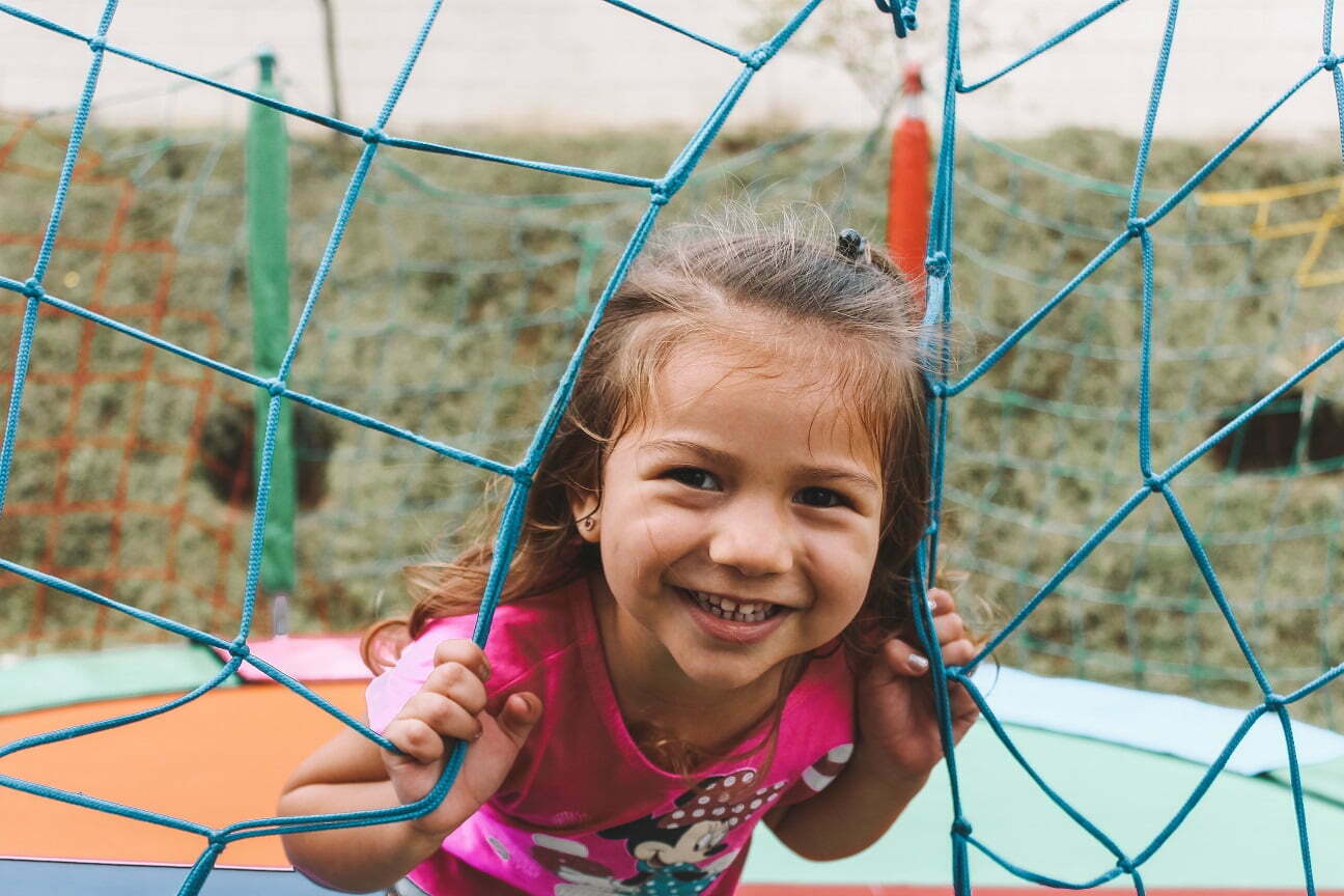 a child at a child care near me playing in a net