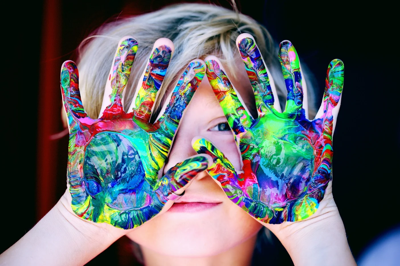 child care child with paint on hands
